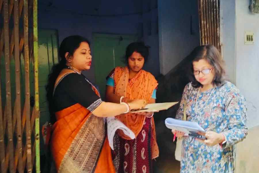 BLO Deepmala Kundu (left) and BLA Sandipa Sarkar (right) visit a voter in Jadavpur on Tuesday.