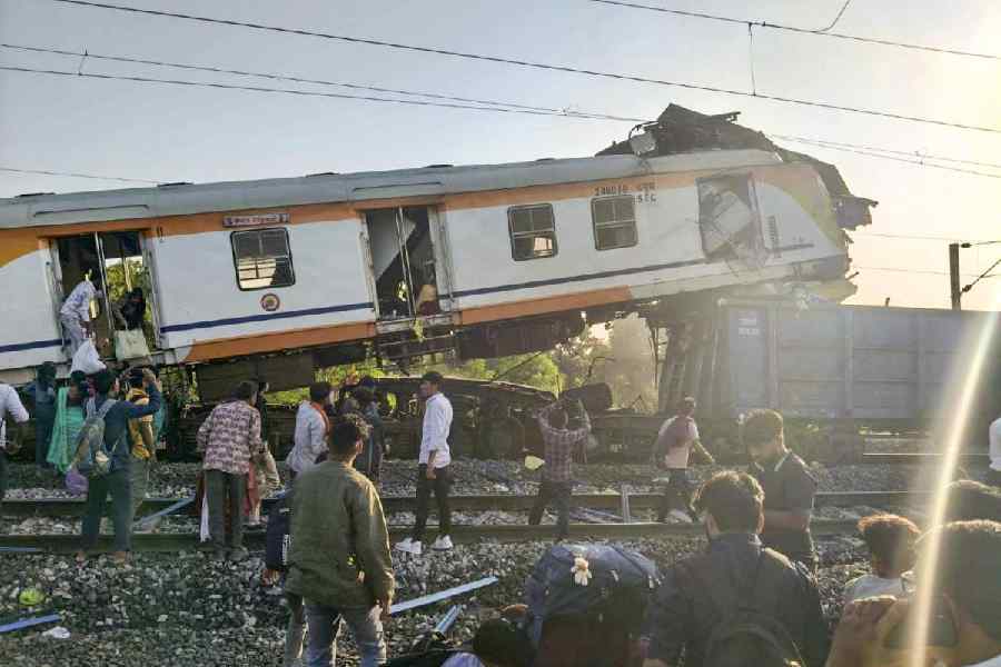 People gather after a passenger train collided with a goods train near Bilaspur railway station, Chhattisgarh, Tuesday, November 4, 2025.