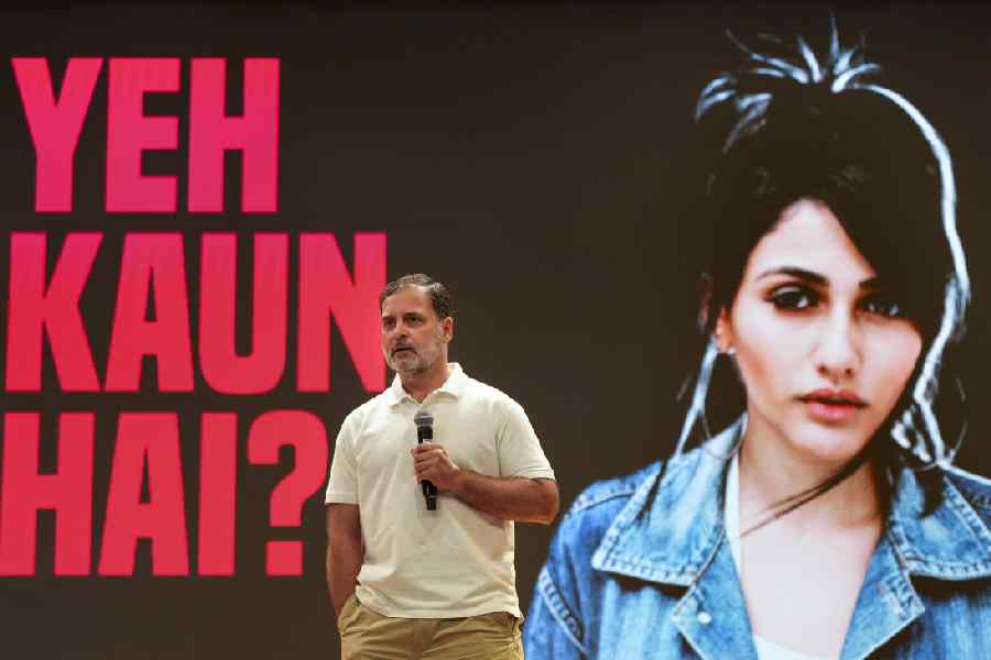 A screen behind Rahul Gandhi at Wednesday's media conference displays a picture of the 'Brazilian model' the Congress leader claims was used alongside names of bogus voters in Haryana.