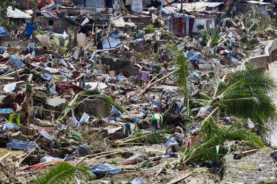 Residents return to what remains of their homes after Typhoon Kalmaegi caused devastation in communities along the Mananga River in Talisay City, Cebu province, central Philippines, Wednesday, Nov. 5, 2025.