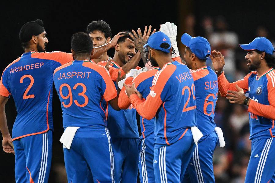 Indian bowler Axar Patel, centre, is congratulated by teammates after dismissing Australian batsman Matt Short during a T20 cricket international between India and Australia in Carrara, Australia