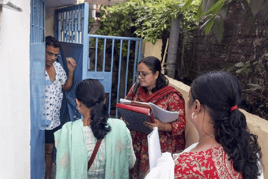 Booth level officers (BLOs) during house-to-house verification as the Special Intensive Revision (SIR) of electoral rolls begins in West Bengal.