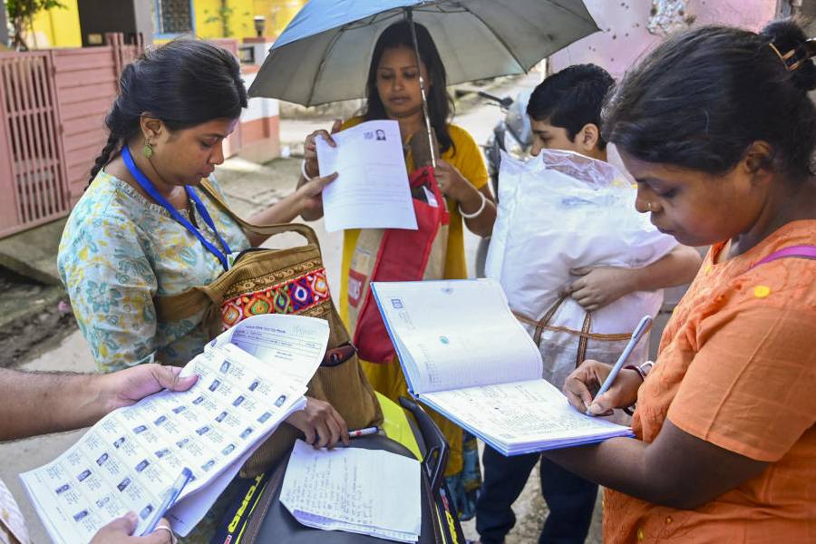 Booth Level Officers on field to distribute enumeration forms to voters as the Special Intensive Revision (SIR) of election rolls begins in West Bengal, at Balurghat in Dakshin Dinajpur district, Tuesday, Nov. 4, 2025.