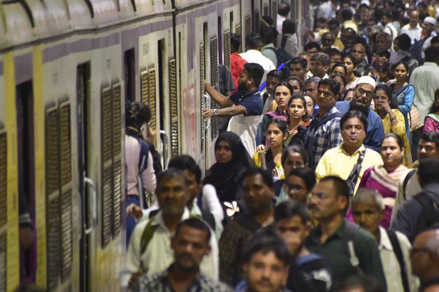 Passengers gather and wait on platforms as railway unions halted local trains during peak hours to protest the FIR filed against engineers in connection with an accident case, at Chhatrapati Shivaji Maharaj Terminus (CSMT), in Mumbai, Thursday, Nov. 6, 2025.