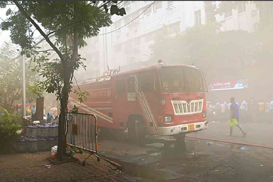 A veil of smoke wraps a stretch of RN Mukherjee Road