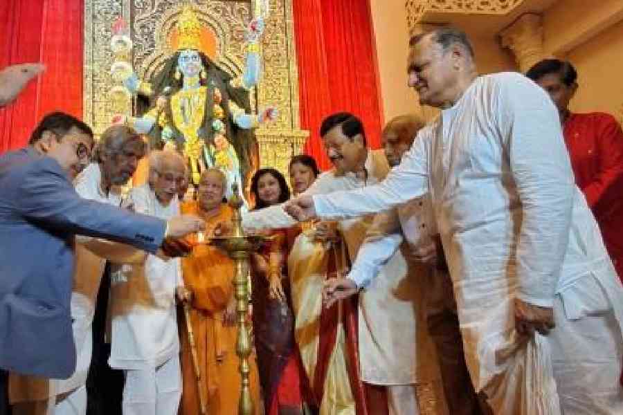 The lamp being lit at Maitri Sangha Kali puja by special guests