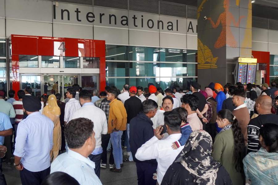 People wait outside the arrivals’ exit at the Indira Gandhi International (IGI) Airport, in New Delhi, in New Delhi, Friday, Nov. 7, 2025.