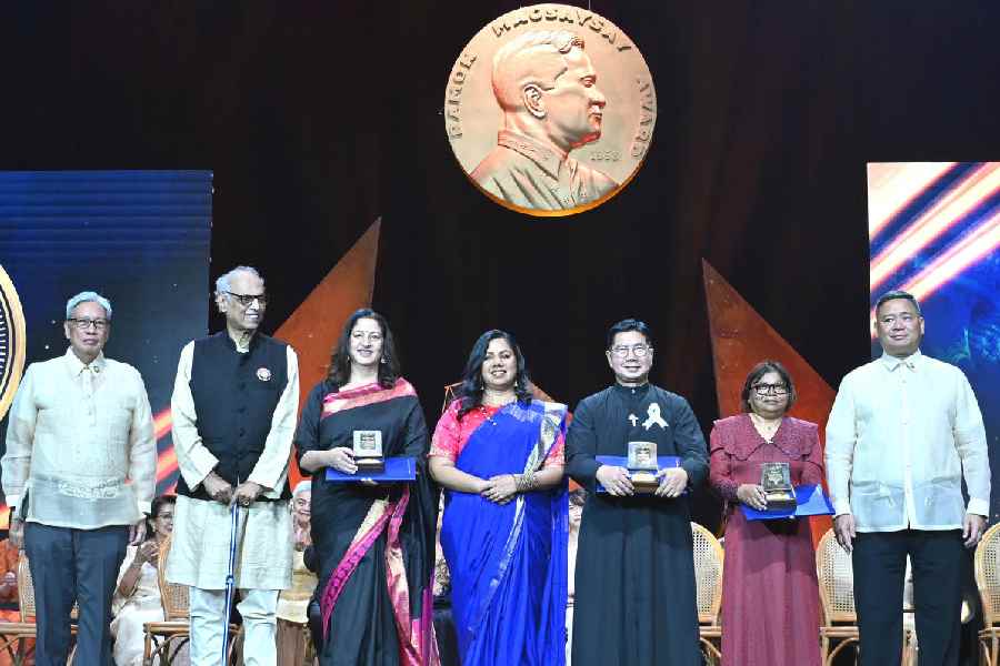 In this photo provided by the Ramon Magsaysay Awards Foundation, Ujwal Thakar, second from left, Safeena Husain, Safeena Husain, 3rd from left, and Gayatri Nair Lobo, center, from the Foundation to Educate Girls Globally based in India, receive the 67th Ramon Magsaysay Award along with fellow awardees Filipino Catholic priest Flaviano Villanueva, 3rd from right, and Maldivian marine ecosystem conservationist Shaahina Ali, 2nd from right, during ceremonies in Manila, Philippines on Friday Nov. 7, 2025. Standing with them is Edgar O. Chua, left, RMAF Chairperson and Francisco Magsaysay, right, grandson of the late Pres. Ramon Magsaysay.