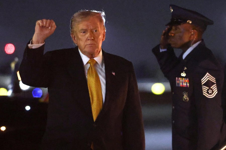 US President Donald Trump pumps his fist after deboarding Air Force One upon his arrival in West Palm Beach, Florida, U.S., November 7, 2025.