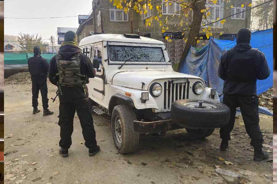 Security personnel keep vigil amid a search operation in Kulgam, Jammu and Kashmir, on Saturday.
