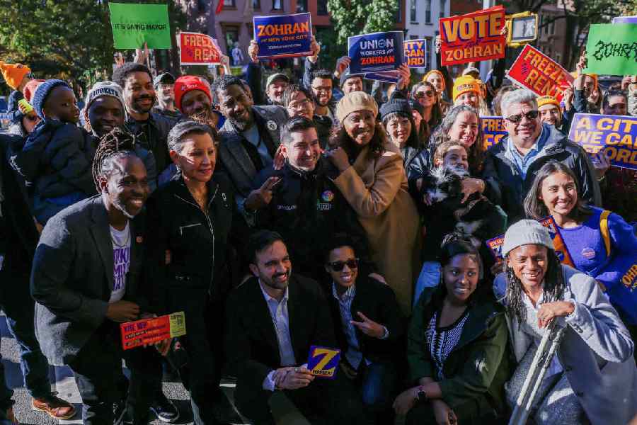 Zohran Mamdani pose for a photo with voters, in the Brooklyn borough of New York City.