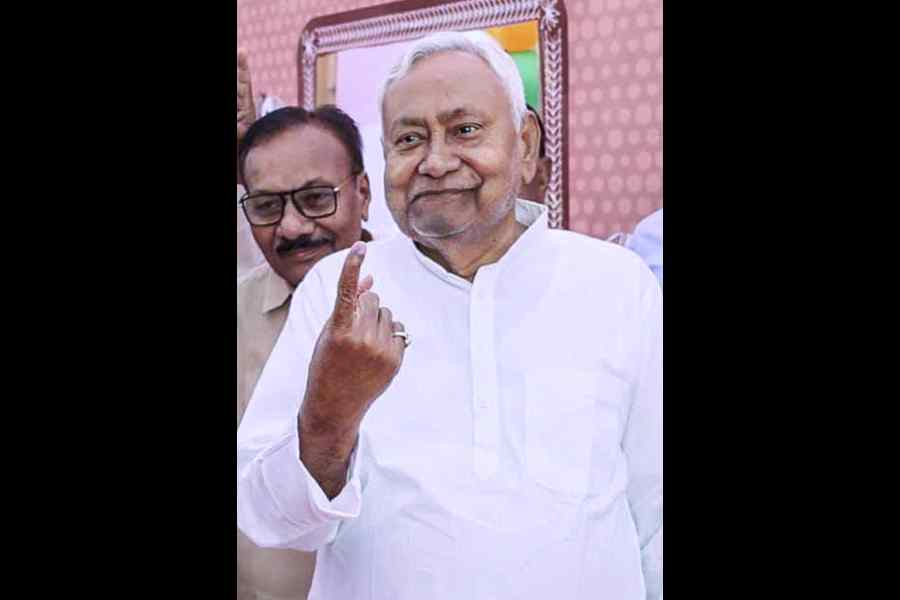 Bihar Chief Minister Nitish Kumar shows his ink marked finger after casting vote during the first phase of Bihar Assembly elections, at Bakhtiyarpur, in Patna district.