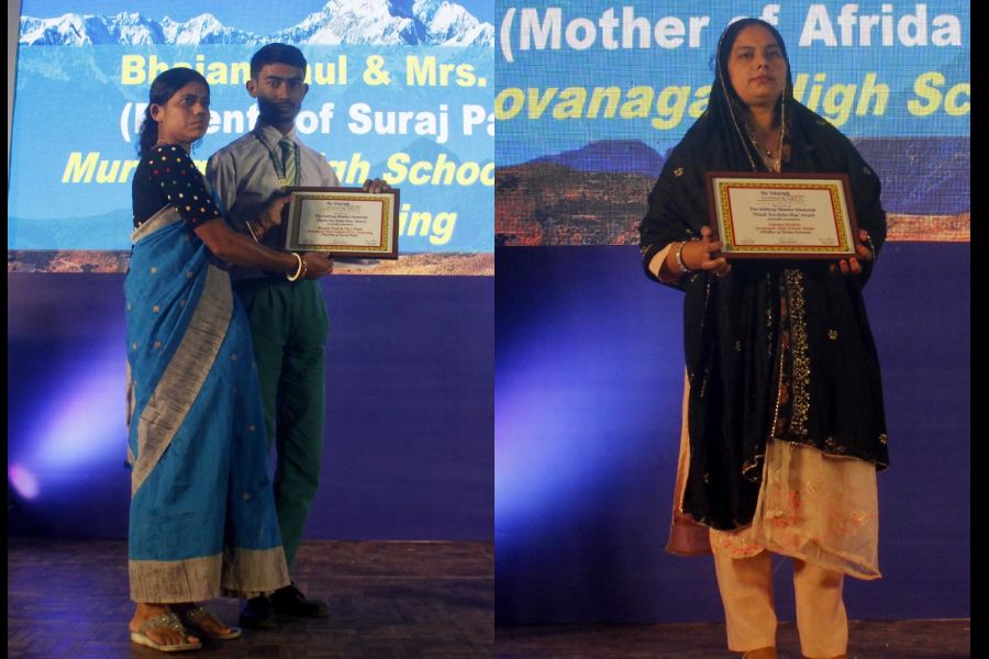 Shampa Paul and her son Suroj at the awards function in Siliguri on Saturday (left); Anjuma Khatun, the mother of Afrida Parveen, at the awards function in Siliguri on Saturday