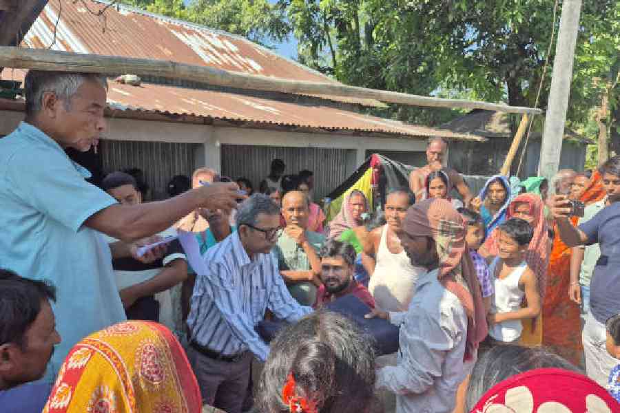 Members of the Indian Dental Association distribute blankets to the flood-hit residents of the Dhupguri block in Jalpaiguri