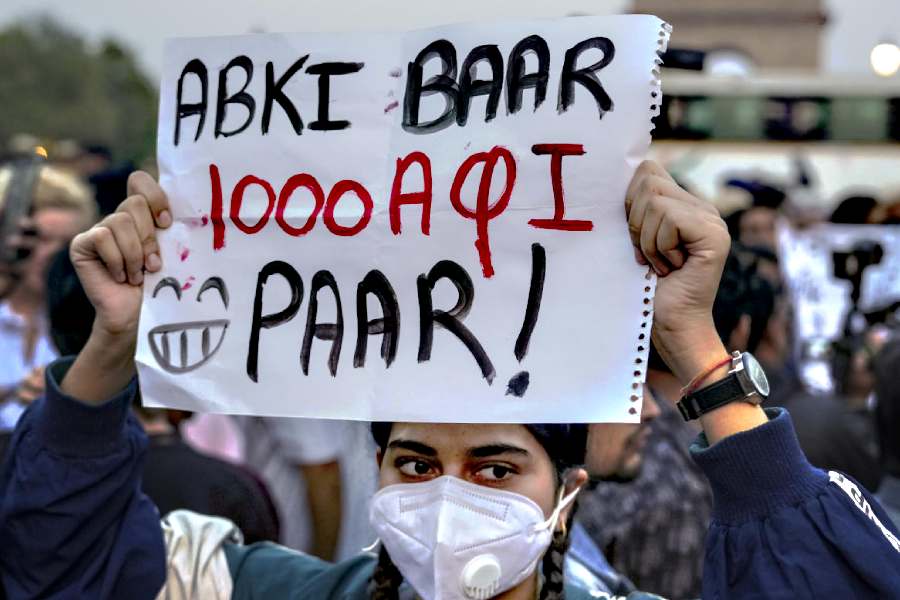 A demonstrator holds a placard during a protest over the deteriorating air quality in the national capital region, in New Delhi