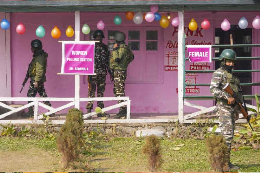 Security personnel at a polling booth in Budgam on Monday. 
