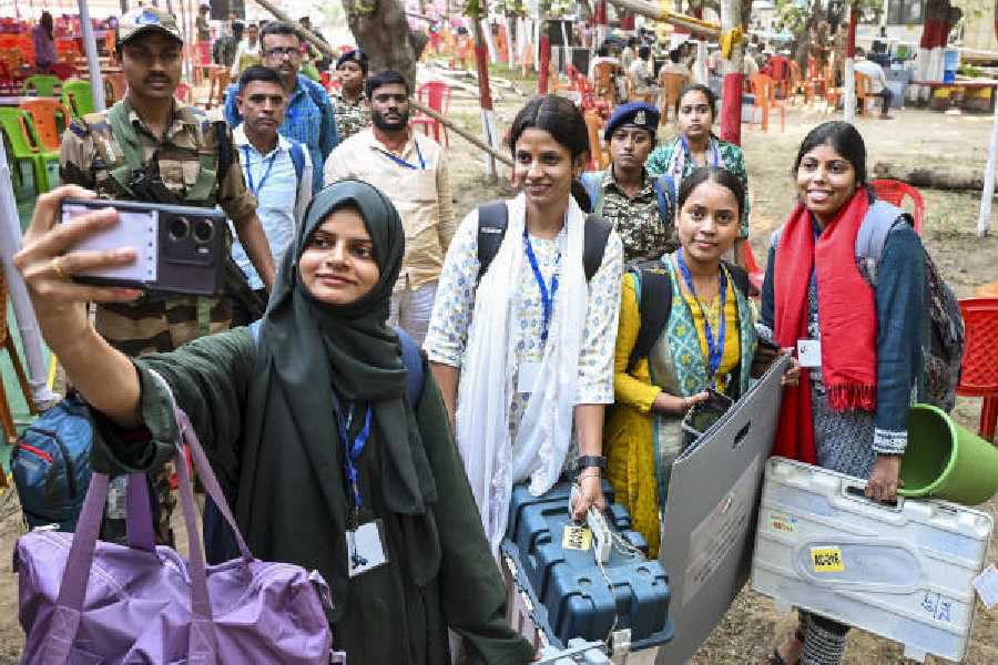 Polling officials click a selfie before leaving for their poll booths in Jehanabad on Monday.