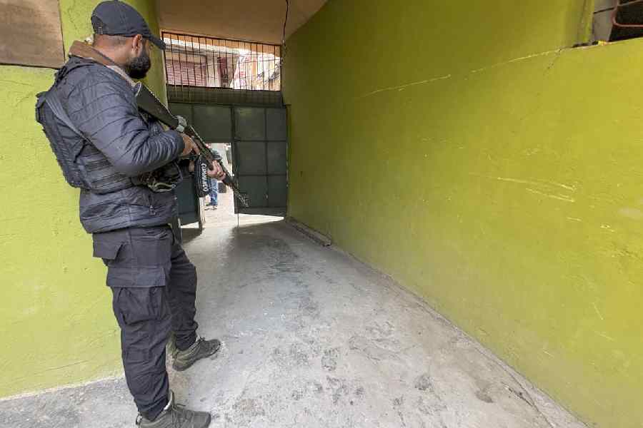 Security personnel stand guard following the arrest of Dr. Adeel (a resident of Wanpora, Kulgam), accused in an interstate and transnational terror module, in Anantnag, Monday, Nov. 10, 2025.