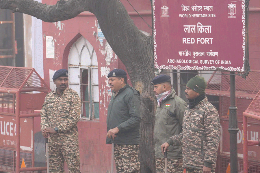 Police personnel stand guard as they cordon off the site in view of the blast that occurred near Red Fort Metro Station on Monday, killing at least nine people and gutting several vehicles, in New Delhi, Tuesday, Nov. 11, 2025.