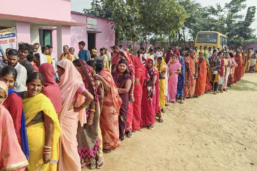 Voters wait in queues to cast their votes during the second and final phase of the Bihar Assembly elections, in Nawada, Bihar