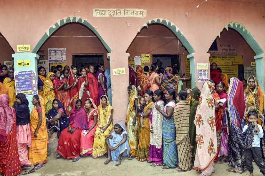 People wait in queues to cast their votes at a polling station during the second and final phase of the Bihar Assembly elections, in Jehanabad, Tuesday, Nov. 11, 2025.
