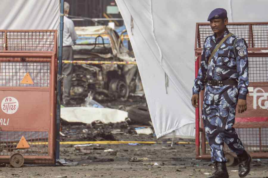 Security personnel at the cordoned off area in view of the blast that occurred near Red Fort Metro Station on Monday, killing 12 people and gutting several vehicles, in New Delhi, Tuesday, Nov. 11, 2025.