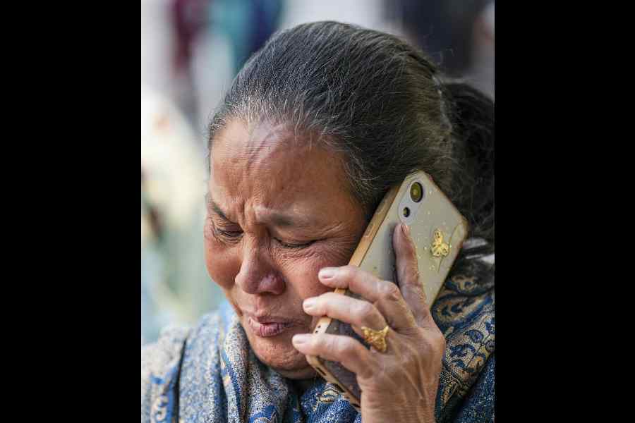 A relative of autorickshaw driver Jumman mourns his death outside a mortuary in New Delhi on Tuesday.