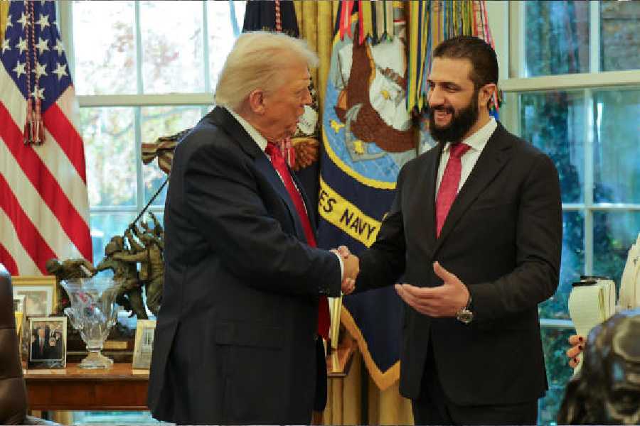 Donald Trump (left) shakes hands with Ahmad al-Shara at the White House on Monday.