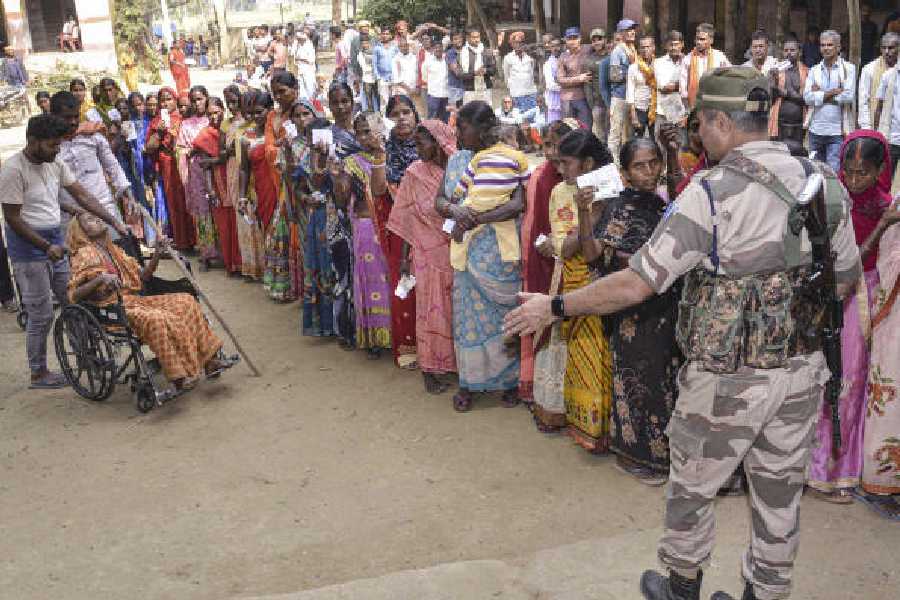 Voters queue up at a polling station in Jehanabad on Tuesday. 