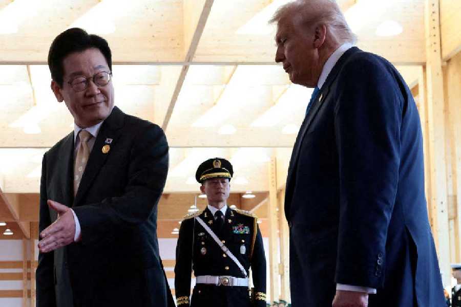 Lee Jae Myung gestures as he meets with Donald Trump on the sidelines of the APEC leaders' summit in South Korea