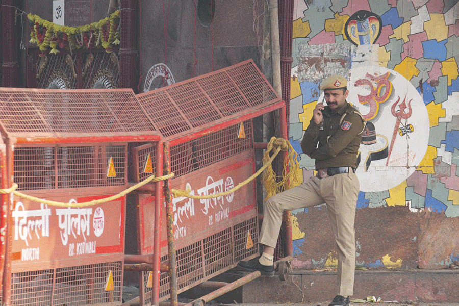 A security personnel stands next to barricades near Red Fort in the wake of a blast on Monday that claimed the lives of 12 people and injured several, in New Delhi, Wednesday, Nov. 12, 2025.