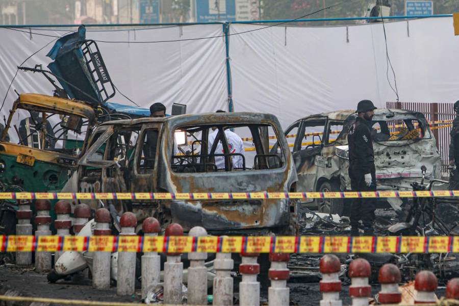 Charred remains of vehicles at a cordoned off area following a blast that occurred near Red Fort Metro Station on Monday, killing at least nine people and gutting several vehicles, in New Delhi, Tuesday, Nov. 11, 2025.