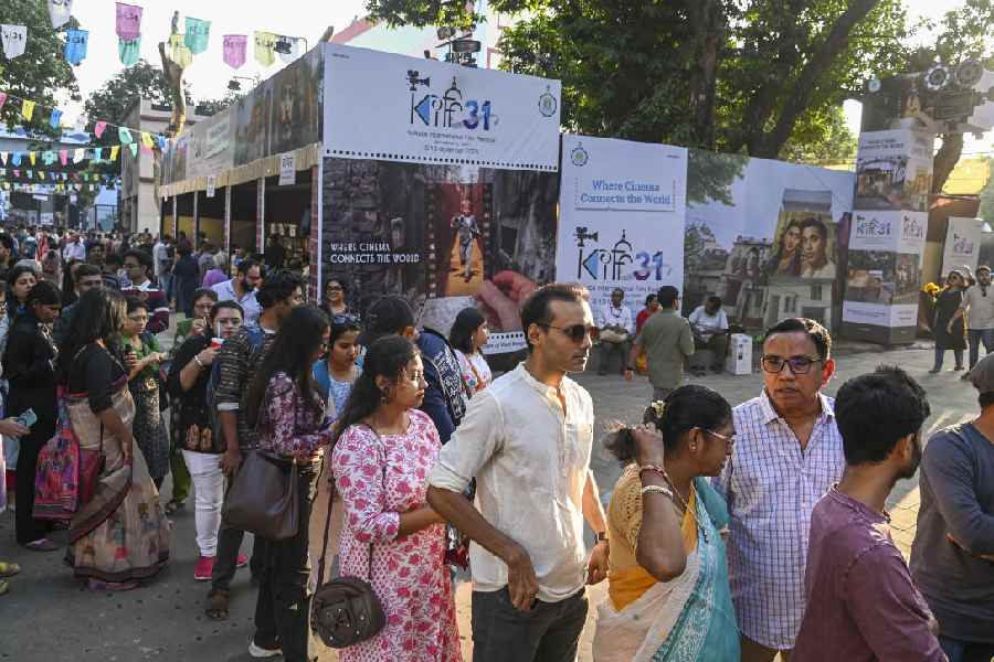 File picture of film enthusiasts waiting in a queue to purchase tickets during the 31st Kolkata International Film Festival in Calcutta.