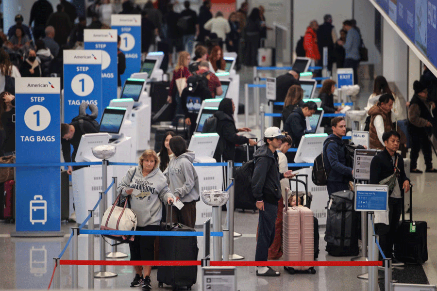 Travelers arrive at check-in for flights departing from Los Angeles International Airport (LAX) in Los Angeles, California, U.S., November 12, 2025.