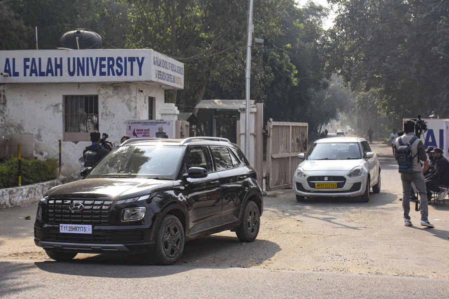 Vehicles exit the Al-Falah University amid investigation in the aftermath of a blast near the Red Fort, in Faridabad, Haryana.