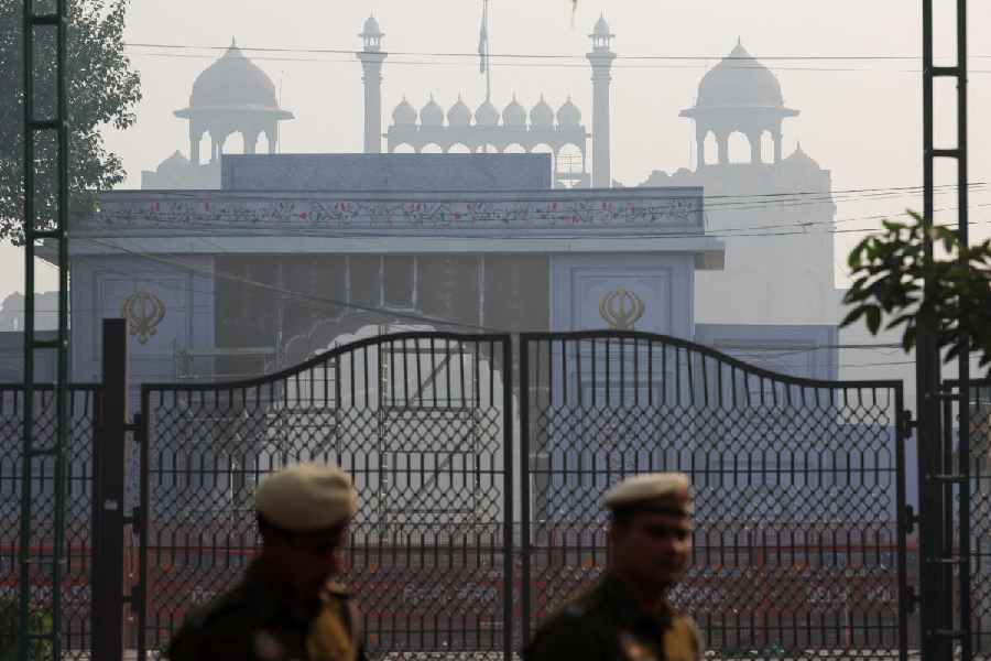 Policemen patrol at the site of an explosion near the historic Red Fort in the old quarters of Delhi