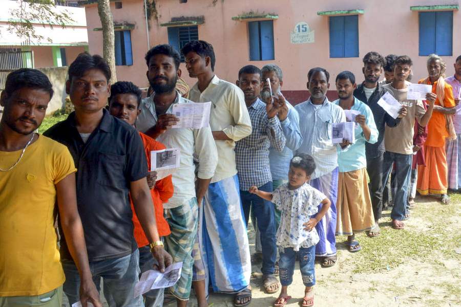 Voters wait in a queue to cast their votes at a polling booth during the second and final phase of the Bihar Assembly elections, in Katihar, Bihar, Tuesday, Nov. 11, 2025.