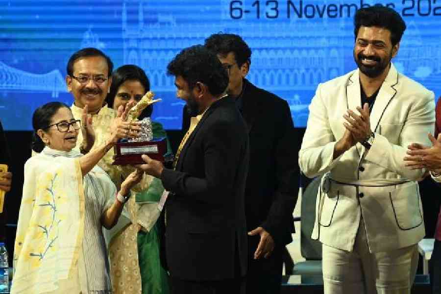 Chief minister Mamata Banerjee presents the Best Director trophy in the Innovation in Moving Images  section to Lalith Rathnayake, director of Riverstone, at Rabindra Sadan on Thursday 