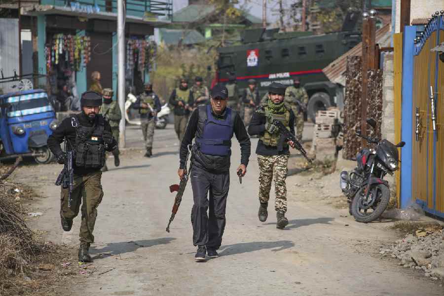 Police conduct raids at a home in Pulwama’s Karimabad village on Thursday. 