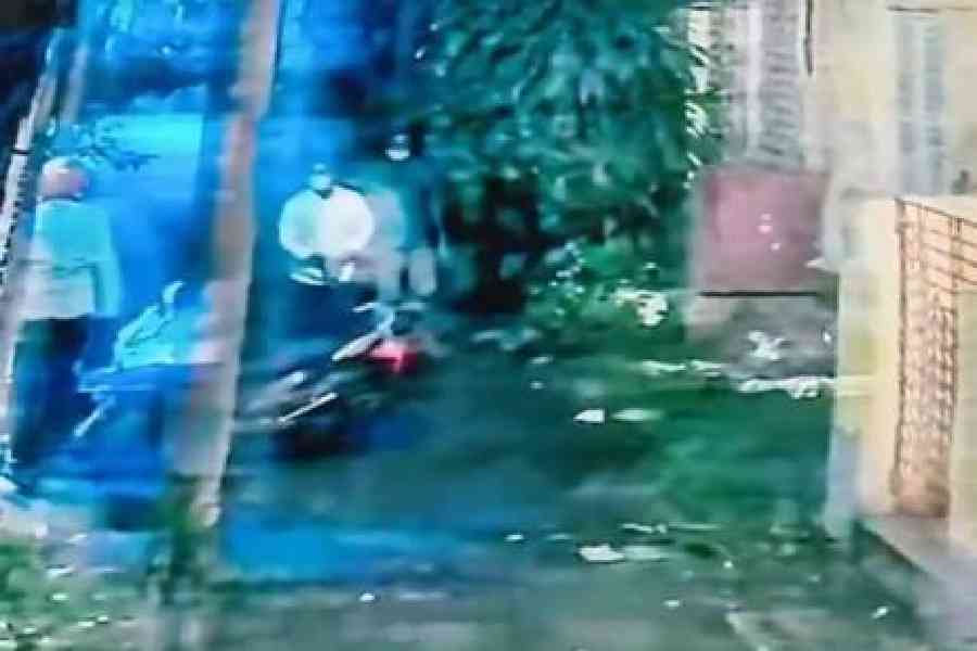 CCTV grab from October shows Sanjit Kuman Das (left), standing near the scooter, while two men (right) walk up to the scooter in Sinthi