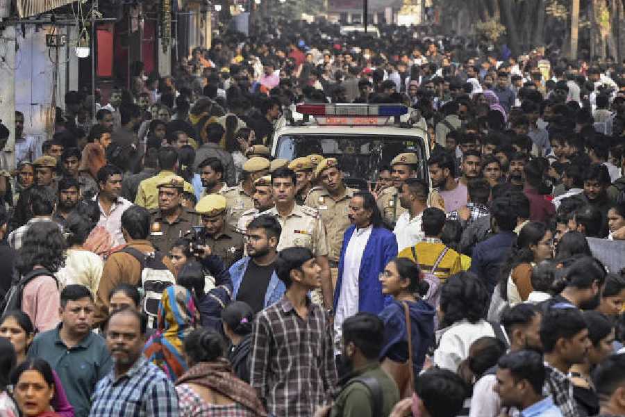Delhi police conduct a flag march amid the heavy rush of people at Sarojini Nagar market in New Delhi on Thursday. 