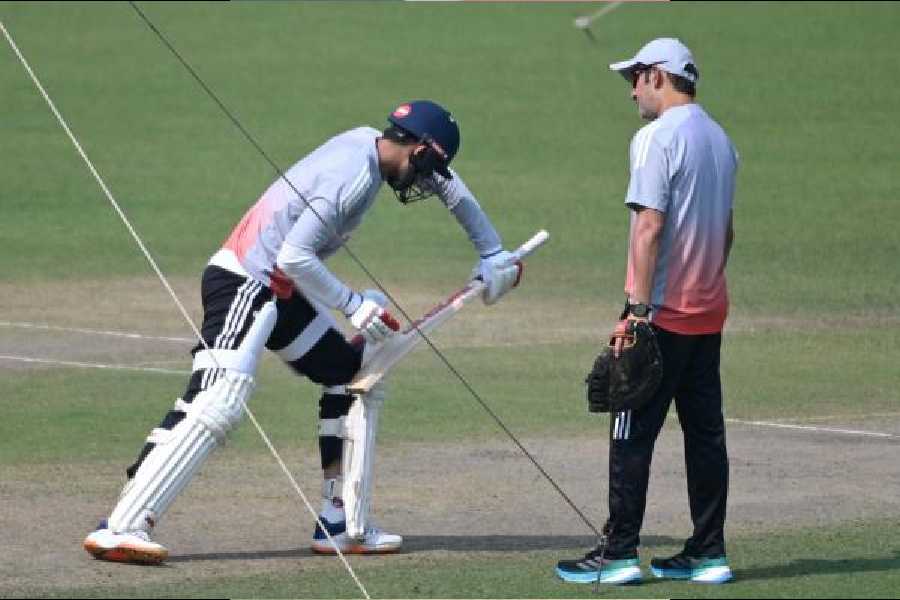Captain Shubman Gill does some shadow practice as coach Gautam Gambhir looks on.