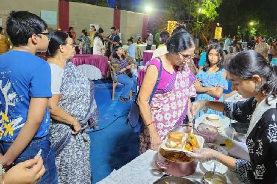 A girl serves meals to guests at AJ Park.