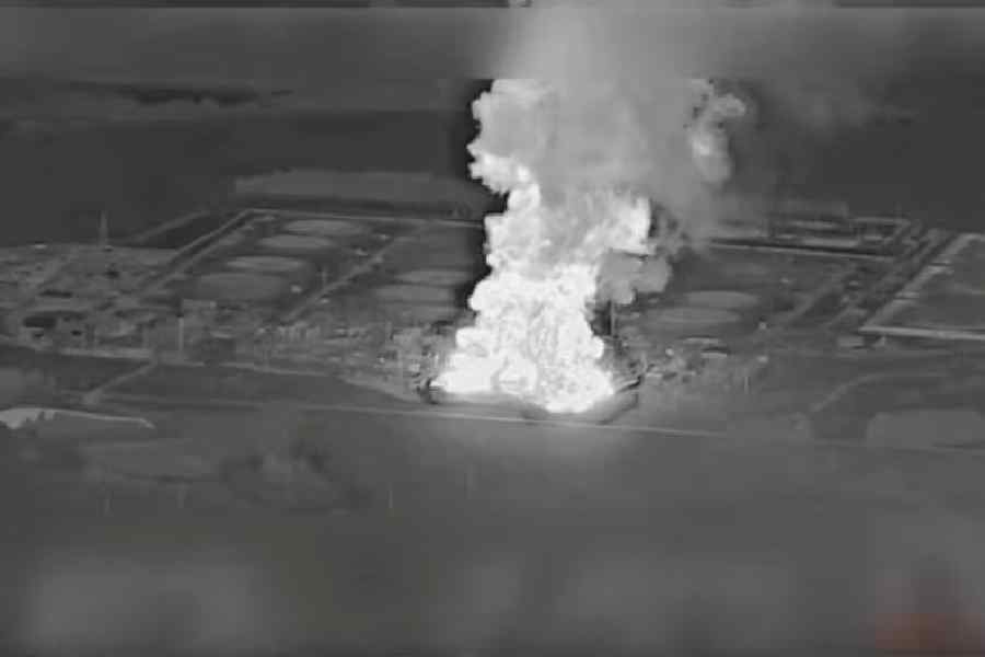 Smoke rises from the Unecha oil pumping station during a fire, in Unechsky district, Bryansk region, Russia, August 21, 2025 in this night vision still image obtained from social media video.