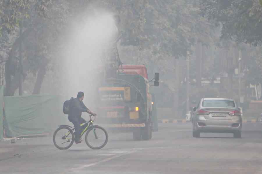 An anti-smog gun sprays water droplets to curb air pollution, in New Delhi, Thursday, Nov. 13, 2025. The city's air quality remained in the 'severe' category for the third consecutive day, according to officials.