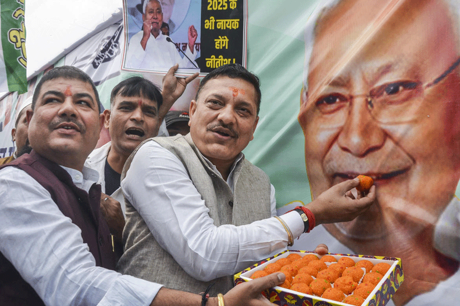 JDU members celebrate as the NDA alliance leads during the counting of votes of the Bihar Assembly elections, in Patna, Friday, Nov. 14, 2025.