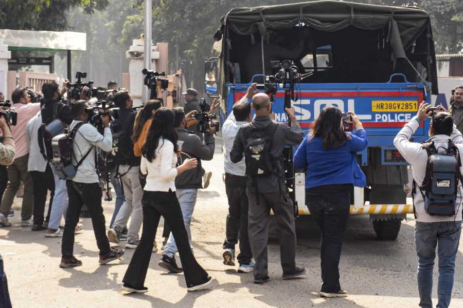 Faridabad: Media personnel look on while a Haryana Police vehicle leaves from the Al-Falah University, in Faridabad, Haryana, Wednesday, Nov. 12, 2025. Under the scanner after the Delhi blast, Al Falah University in Haryana's Faridabad on Wednesday said it has only a professional association with the two of its doctors arrested in connection with the incident and is anguished by the unfortunate development