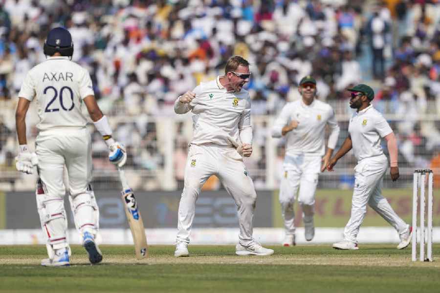 South Africa's Simon Harmer, center, celebrates the wicket of India’s Ravindra Jadeja on day two of the first Test cricket match of a series between India and South Africa, at the Eden Gardens