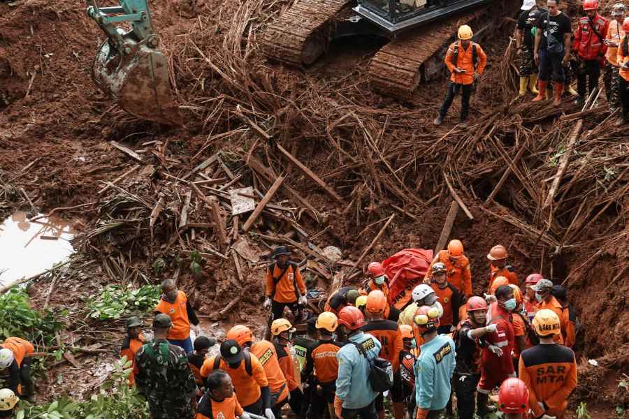 Indonesian rescue members search for victims at the site of a landslide, which hit Cibeunying village on November 13, in Cilacap, Central Java province, Indonesia, November 15, 2025.