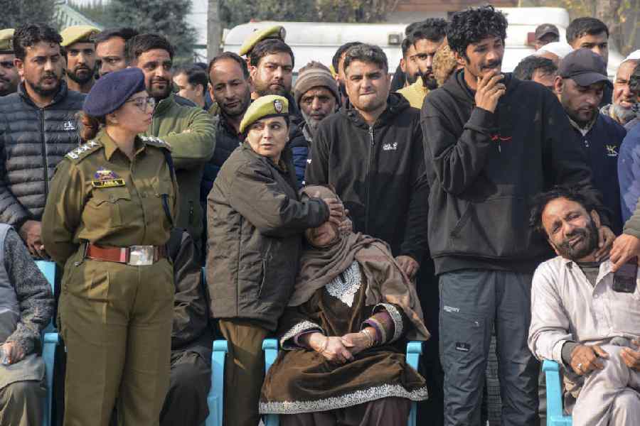 Bereaved family members of the nine persons killed in the accidental blast at Nowgam police station mourn during their tribute ceremony at the Police Control Room, in Srinagar, Saturday.